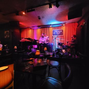 Black Cat - a band playing in a dimly lit room - New American Near Me - San Francisco, California