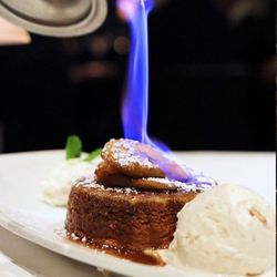 Eddie V's Prime Seafood - Our signature Bananas Foster is flambéed tableside and served with butter pecan ice cream.