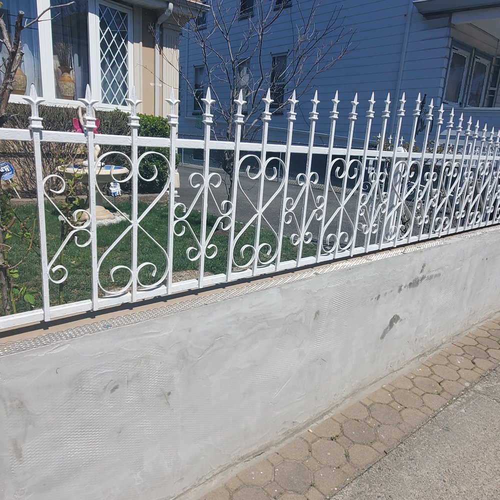 A1 Armor Construction - a white picketed fence in front of a house - General Contractors Near Me - Paterson, New Jersey