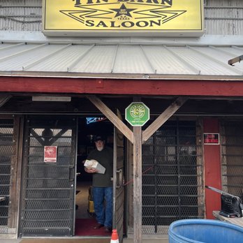 Old Tin Barn Saloon - a man entering the door - Dive Bars Near Me - San Antonio, Texas