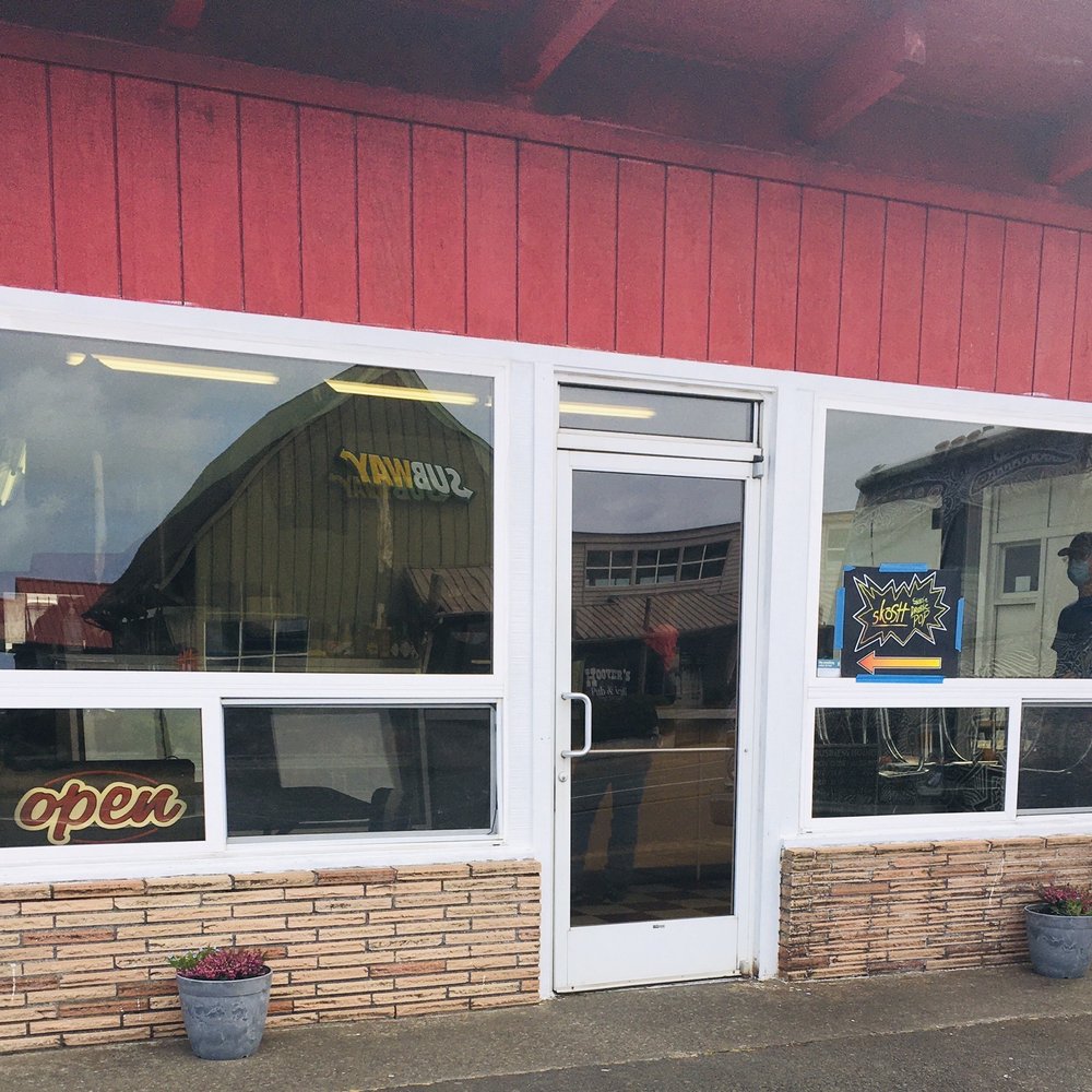 Skosh - a man standing outside of a restaurant - Burgers Near Me - Waldport, Oregon Skosh - a man standing outside of a restaurant - Burgers Near Me - Waldport, Oregon