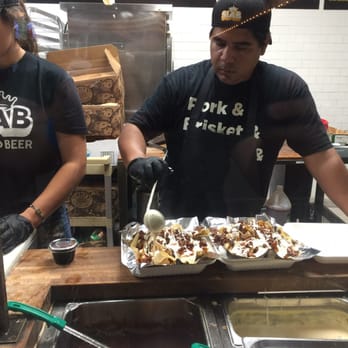 Stack City BBQ & Beer - What do you get when you combine pickles, cheese, chips, jalapeños and Slab's amazing pulled pork?  Love. Best nachos ever. - Barbeque Near Me - Austin, Texas