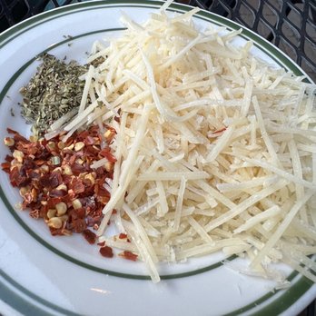 SouthCreek Pizza - Fresh toppings for the pizza: oregano, crushed red pepper flakes, Parmesan - Pizza Near Me - Reno, Nevada