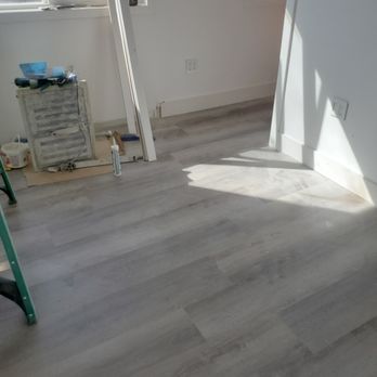 Blacklotus Renovations - a room with white walls and wood floors - General Contractors Near Me
