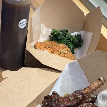 Ashantis Kitchen & Catering - a box of ribs and a bottle of ketchup - Caterers Near Me - Philadelphia, Pennsylvania