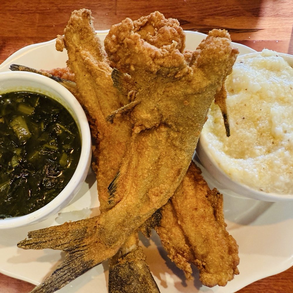 Southern Shores Seafood - Whole catfish, grits, collards, and includes hush puppies (under the catfish) - Seafood Near Me - Jacksonville, Florida Southern Shores Seafood - Whole catfish, grits, collards, and includes hush puppies (under the catfish) - Seafood Near Me - Jacksonville, Florida