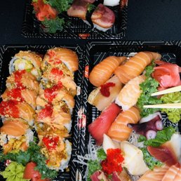 Top tray eel unagi nigiri with roasted duck nigiri below it. Left red dragon and salmon lover. Right sashimi/ nigiri combo