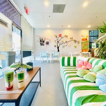 Tea Amo - a green and white striped couch in a brightly decorated office - Bubble Tea Near Me - Manteca, California
