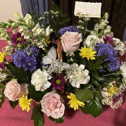 A variety of flowers for a sympathy basket.