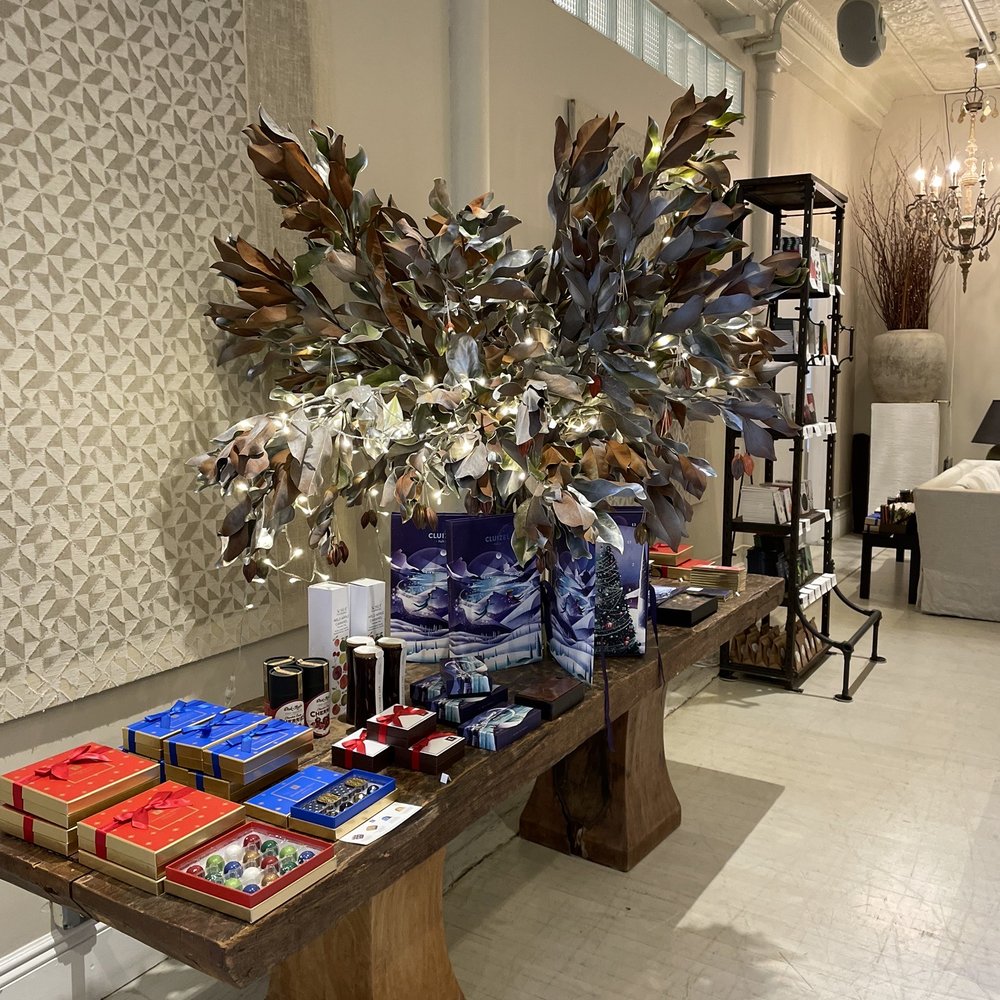 Cocoa Store - a table with books and a vase of flowers - Chocolatiers & Shops Near Me - New York, New York