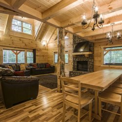 Hickory Hill Lodge - Living room with wood burning fireplace adjacent to a dining table large enough for everyone.