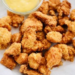 Popcorn chicken~ choice of toppings, hot Cheetos, takis, parmesan cheese, Cajun and original