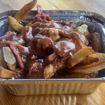 Poutineville - a container of french fries - Poutineries Near Me - Montreal, Quebec Poutineville - a container of french fries - Poutineries Near Me - Montreal, Quebec