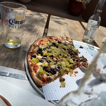 Village Pizza - a slice taken out of the pizza - Pizza Near Me - Corrales, New Mexico