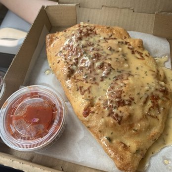 Fratelli Pizza - Calzone with some weird spicy sauce on top.  Gross! - Pizza Near Me - West Wendover, Nevada