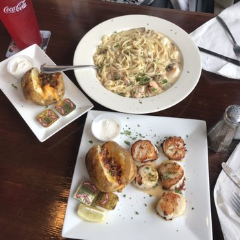 The Anchor - Scallops with a loaded baked potato, and the Seafood Americana with a loaded baked potato on the side. - Seafood Near Me - Flagler Beach, Florida
