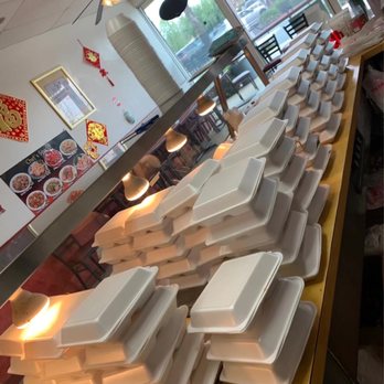 Express Wok - a large number of trays of food on a counter - Chinese Near Me - Brea, California
