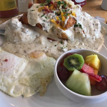 Buttermilk - Fried chicken on top of biscuits with sausage gravy, and eggs.   Side of fruit. - Coffee & Tea Near Me - Geneva, Illinois