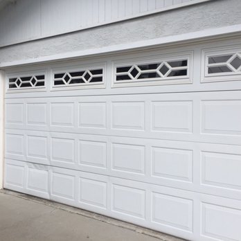 Tony's Garage Doors - Old door with dent from previous owner - Garage Door Services Near Me Tony's Garage Doors - Old door with dent from previous owner - Garage Door Services Near Me