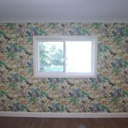 Nursery accent wall - they placed the paper so that the monkeys weren't cut off by the window, and were symmetrical.