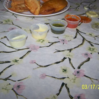 Arepa Xpress - Tablespoon size sauce cups half filled. - Venezuelan Near Me - Spring, Texas Arepa Xpress - Tablespoon size sauce cups half filled. - Venezuelan Near Me - Spring, Texas