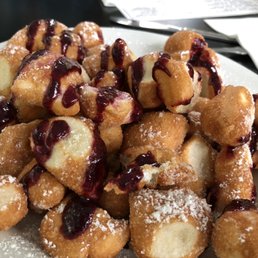 Hot from the pan, Beignets drizzled with raspberry sauce. Hot from the pan, Beignets drizzled with raspberry sauce.