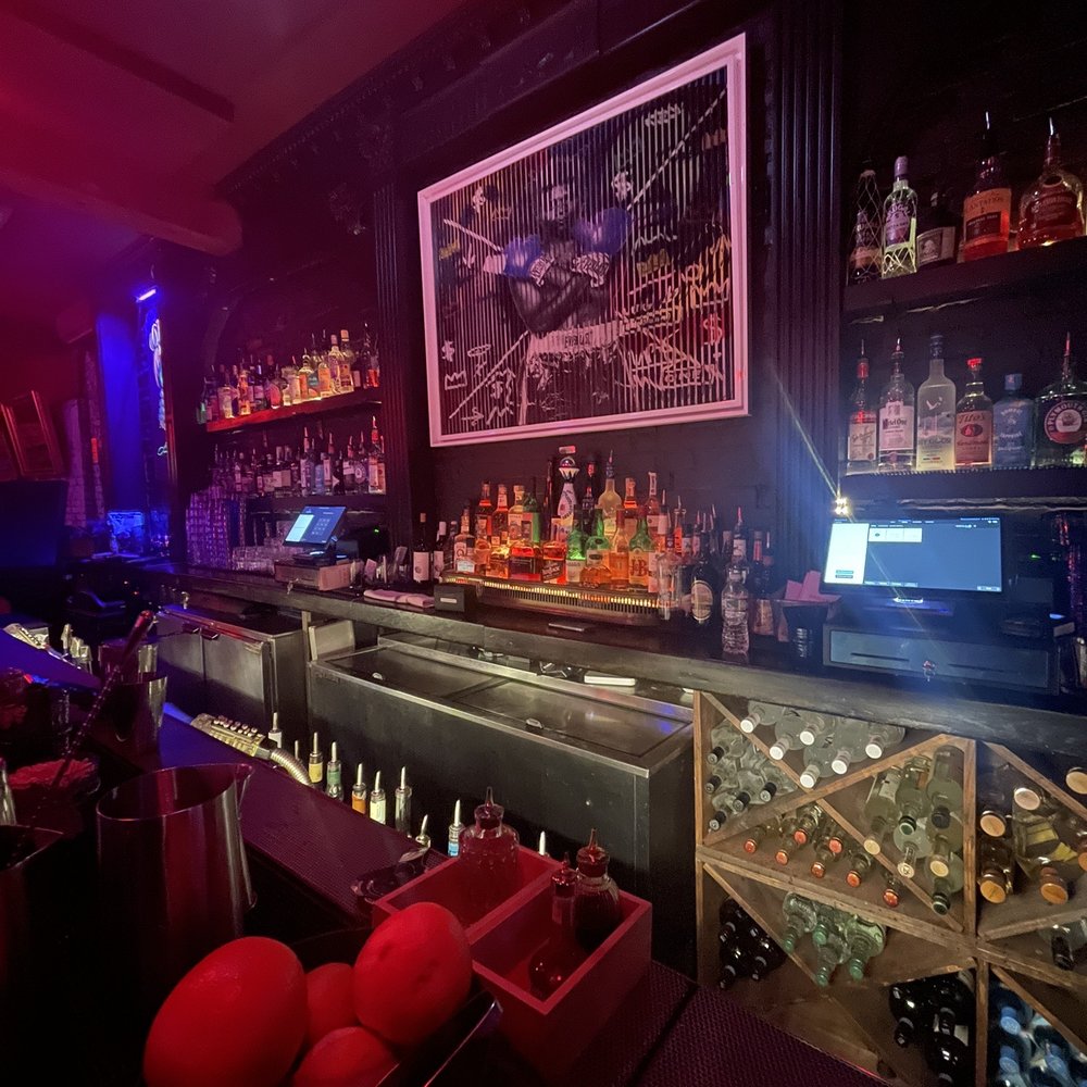 a bar filled with bottles of alcohol a bar filled with bottles of alcohol