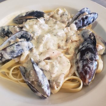 Villa Palma - a plate of pasta with mussels and sauce - Italian Near Me - San Angelo, Texas Villa Palma - a plate of pasta with mussels and sauce - Italian Near Me - San Angelo, Texas
