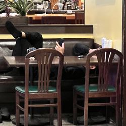 Surin of Thailand - Waiter during open hours in main dining room. Was rubbing feet on back of booth