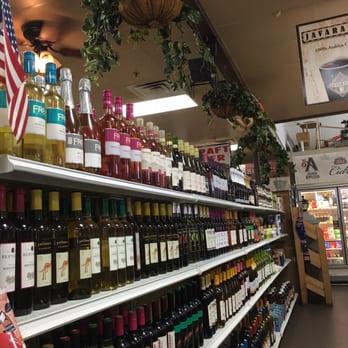 Milk 'N Things -  grocery store aisle filled with bottles of wine - Delis Near Me - Port St. Lucie, Florida