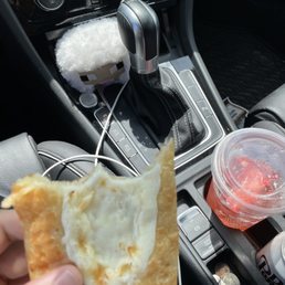 a person holding a piece of bread in their hand a person holding a piece of bread in their hand