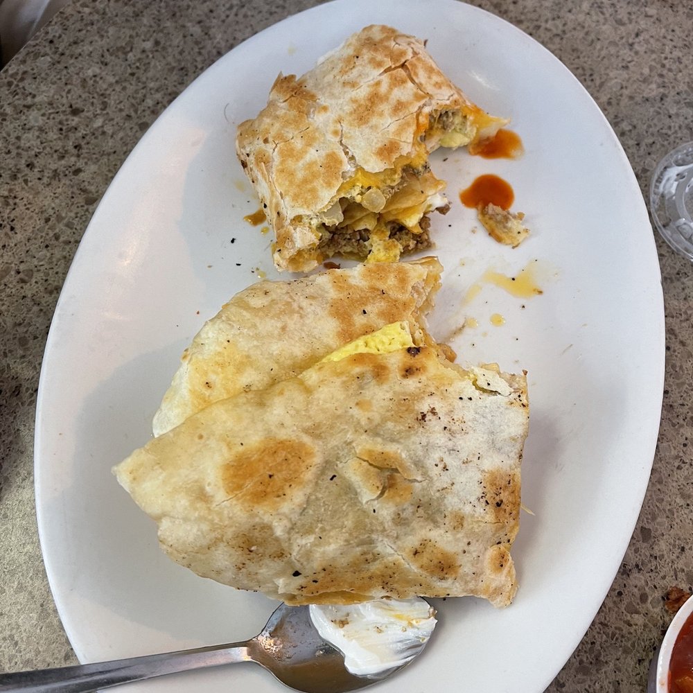 Southwest Breakfast burrito served with sour cream and salsa on the side Southwest Breakfast burrito served with sour cream and salsa on the side