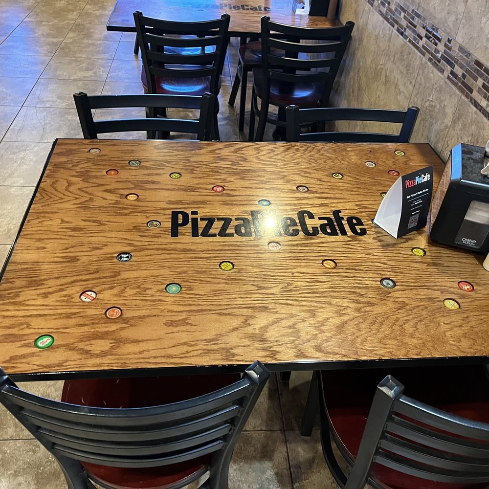 Pizza Pie Café - a wooden table and chairs - Pizza Near Me - Twin Falls, Idaho Pizza Pie Café - a wooden table and chairs - Pizza Near Me - Twin Falls, Idaho