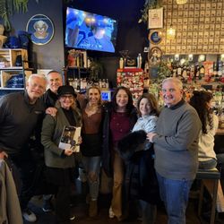 The Cork & Cast - Our group with the owner/chef and her magazine article.