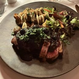 Seared duck in a blueberry sauce, with potatoes and salad. Seared duck in a blueberry sauce, with potatoes and salad.