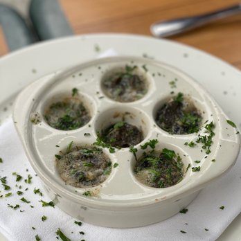 Maximilien - Escargots à la Bourguignonne- Baked escargot in a garlic and parsley butter. - French Near Me - Seattle, Washington Maximilien - Escargots à la Bourguignonne- Baked escargot in a garlic and parsley butter. - French Near Me - Seattle, Washington