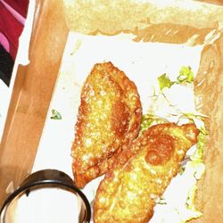Izlas Latin Cuisine - My two empanadas that they didn't even put a cap on creme so it was all over the food