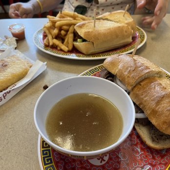 Phodega - The Viet Dip (bottom right)  Spicy Chicken Banh Mi w/ fries (top) Pizza Puff (left) - Vietnamese Near Me - Chicago, Illinois