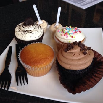 The Cup - (Clockwise starting at top left:) tuxedo, confetti, double chocolate, and yellow cake (without frosting) cupcakes - Desserts Near Me - Saint Louis, Missouri The Cup - (Clockwise starting at top left:) tuxedo, confetti, double chocolate, and yellow cake (without frosting) cupcakes - Desserts Near Me - Saint Louis, Missouri