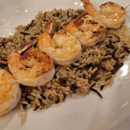 Side of grilled shrimp on pilaf rice Side of grilled shrimp on pilaf rice