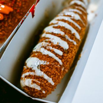 Two Hands - a hot dog in a box with ketchup - Hot Dogs Near Me - Spring, Texas