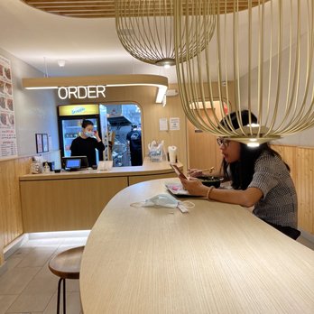 Silky Kitchen - a woman using her cell phone - Chinese Near Me - New York, New York