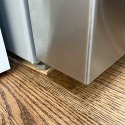 Bob Grant Construction - Refrigerator that despite the adjustable being extended as much as possible still need shims.  The back rollers also need to be elevated.