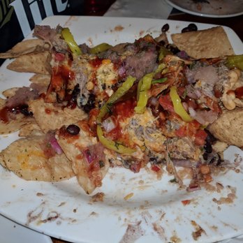 Buzzard Billy's - We're about two-thirds finished with the pulled pork nachos. This would be too much for one person as a entree! - American Near Me - La Crosse, Wisconsin