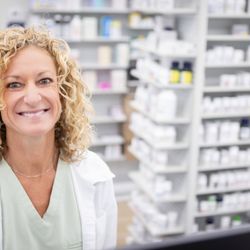 Cypress Wellness Pharmacy - Employee in front of prescription shelves