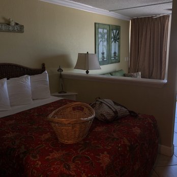 Barefoot Beach Hotel - Queen bed, living room space, and door out to balcony - Hotels Near Me - Madeira Beach, Florida Barefoot Beach Hotel - Queen bed, living room space, and door out to balcony - Hotels Near Me - Madeira Beach, Florida