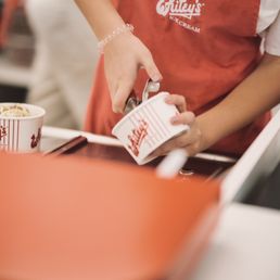 a person pouring milk into a cup a person pouring milk into a cup