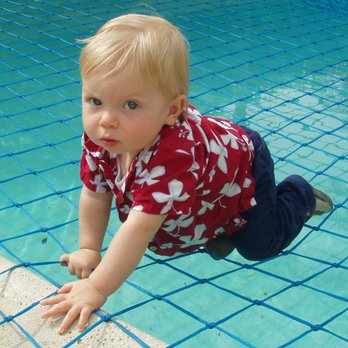 All-Safe Pool Fence & Covers - Long Beach - Small child on a pool safety net - Fences & Gates Near Me All-Safe Pool Fence & Covers - Long Beach - Small child on a pool safety net - Fences & Gates Near Me