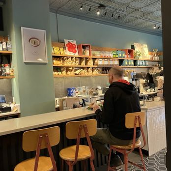 Koma Cafe - a man sitting at the counter - Coffee & Tea Near Me - Takoma Park, Maryland