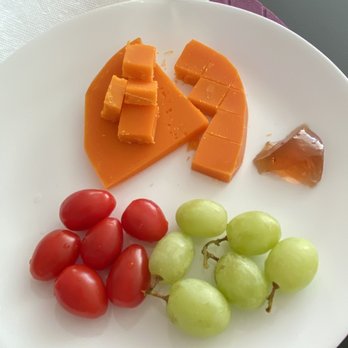 D Original Sausage Haus - The lovely mimolette in my mini cheese snack plate with moscato. The blob is pomegranate hot pepper jelly. - Delis Near Me - Richmond, British Columbia